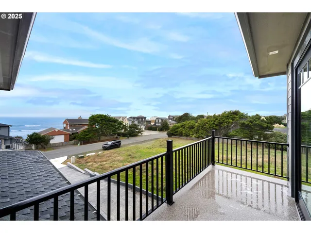 a view of a balcony with wooden floor and fence