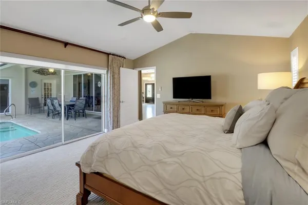 a bedroom with a bed and large mirror