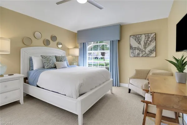 a bedroom with a large bed and a couch