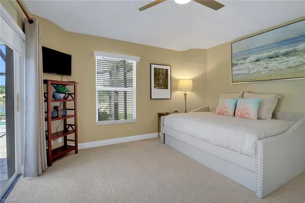 a bedroom with a bed a television and a window