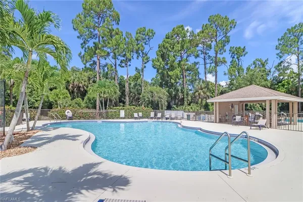 a view of a backyard with swimming pool