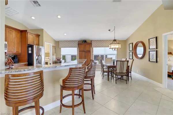 a view of a dining room with furniture and a chandelier