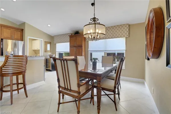 a view of a dining room with furniture and chandelier
