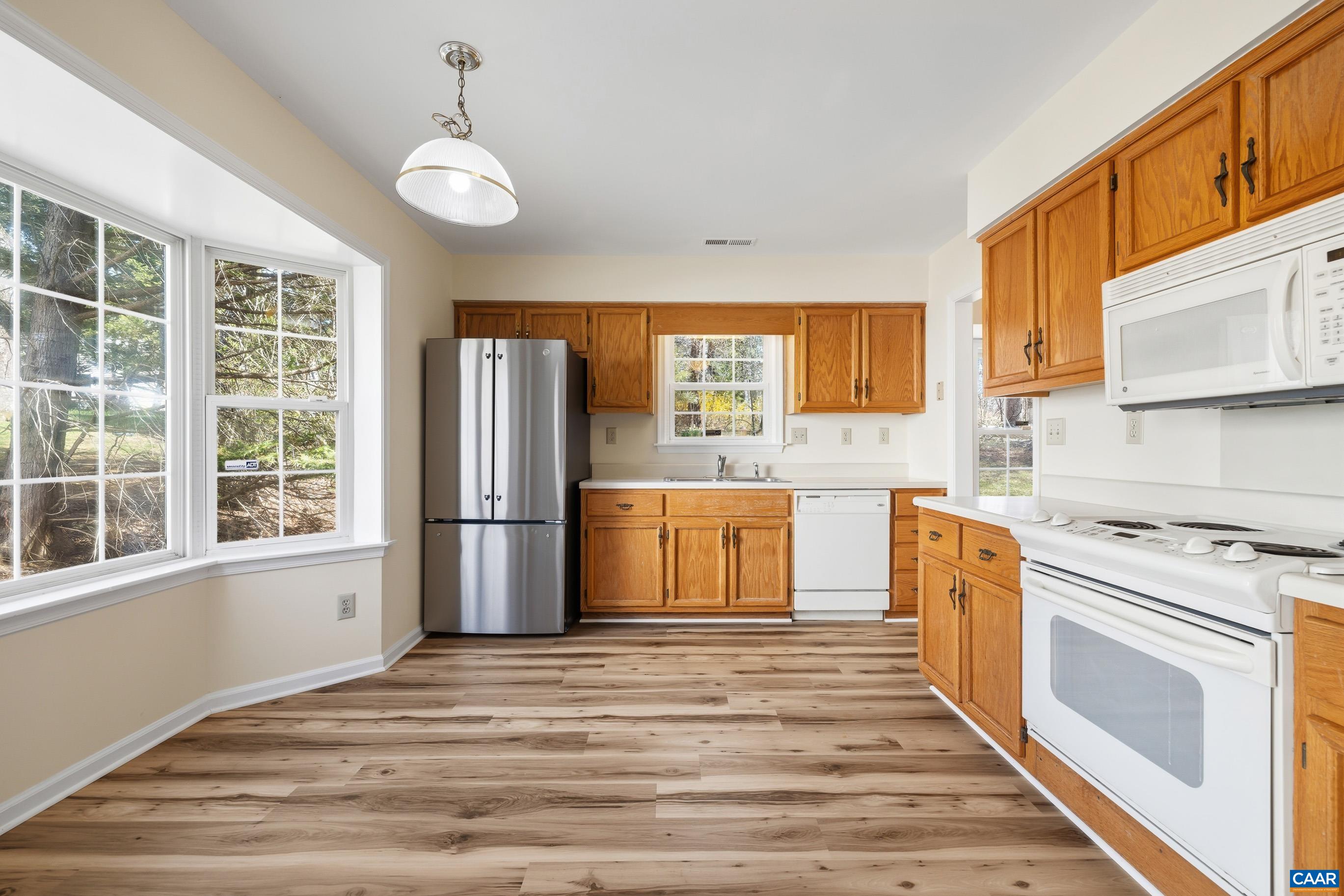 3041 Copper Knoll Road Charlottesville, VA 22911 - Photo 14 of 30 a kitchen with stainless steel appliances granite countertop a stove and a refrigerator
