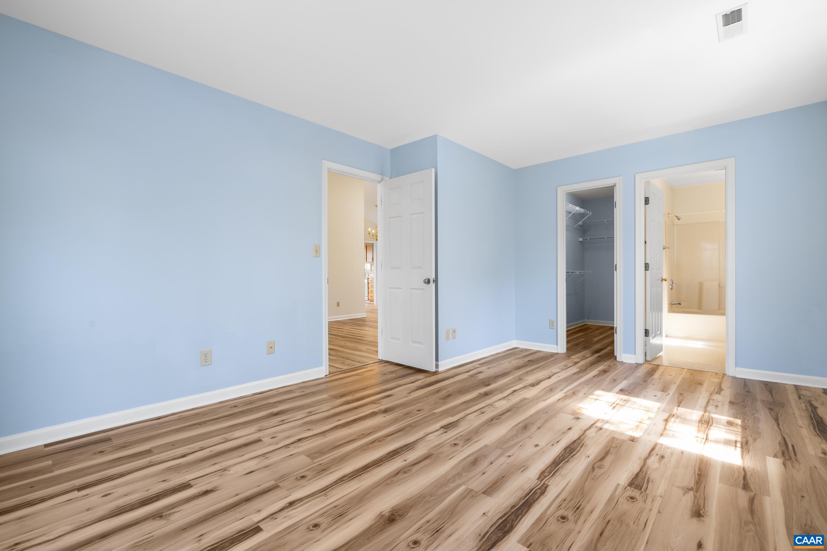 3041 Copper Knoll Road Charlottesville, VA 22911 - Photo 17 of 30 a view of an empty room with wooden floor