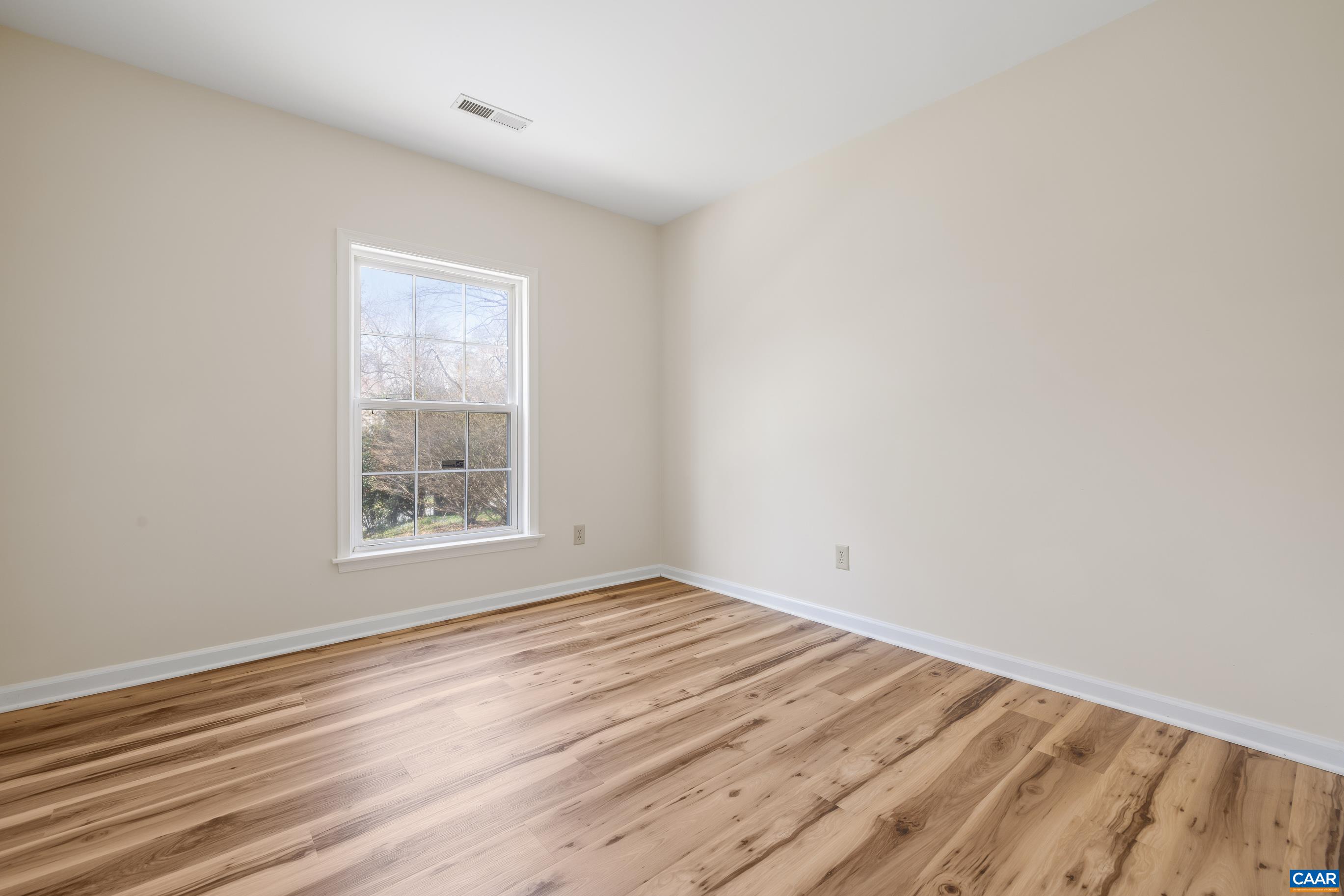 3041 Copper Knoll Road Charlottesville, VA 22911 - Photo 23 of 30 an empty room with wooden floor and windows