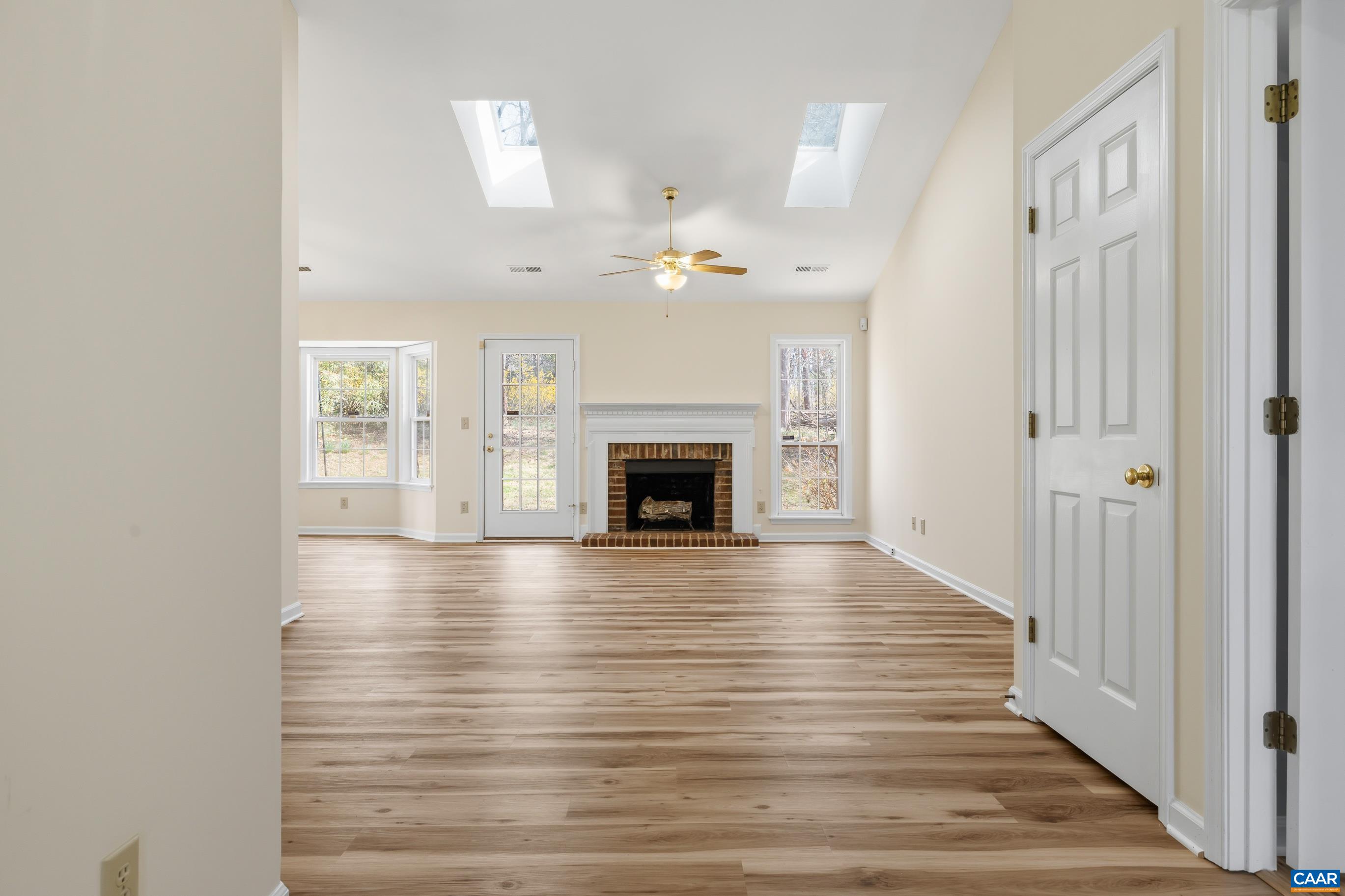 3041 Copper Knoll Road Charlottesville, VA 22911 - Photo 3 of 30 wooden floor in an empty room with a fireplace