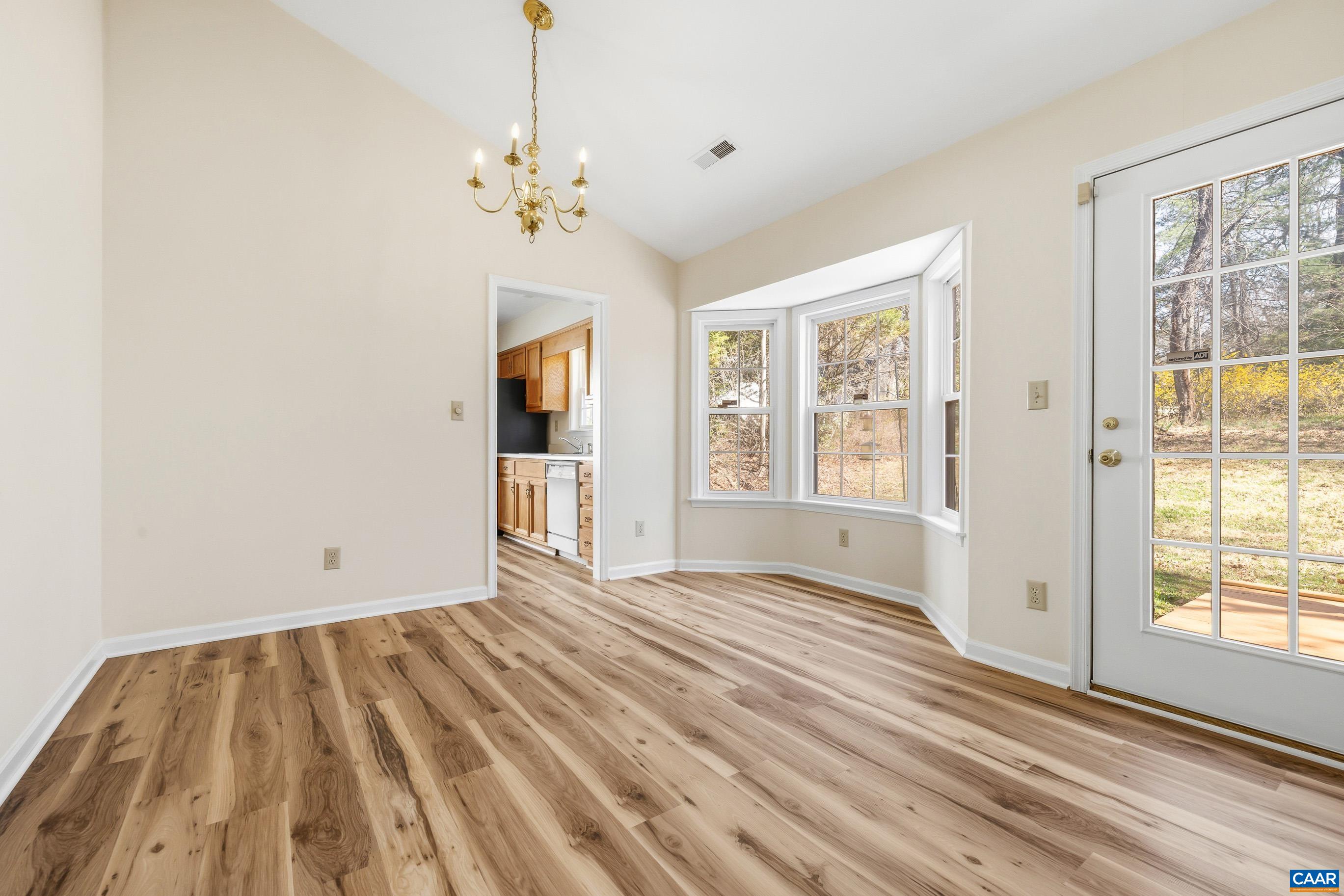 3041 Copper Knoll Road Charlottesville, VA 22911 - Photo 8 of 30 a view of an empty room with a window and wooden floor