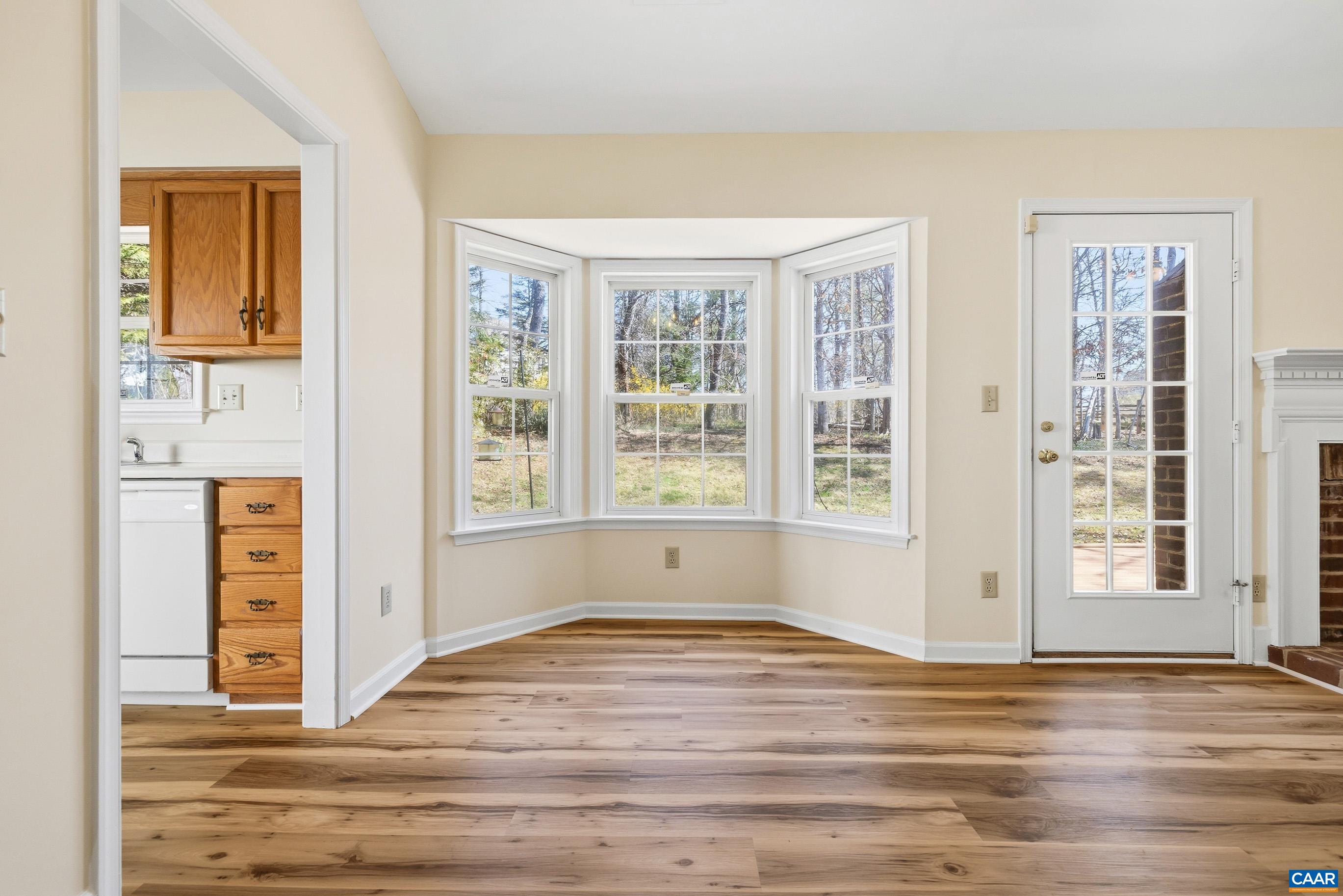 3041 Copper Knoll Road Charlottesville, VA 22911 - Photo 9 of 30 a view of an empty room with window and wooden floor
