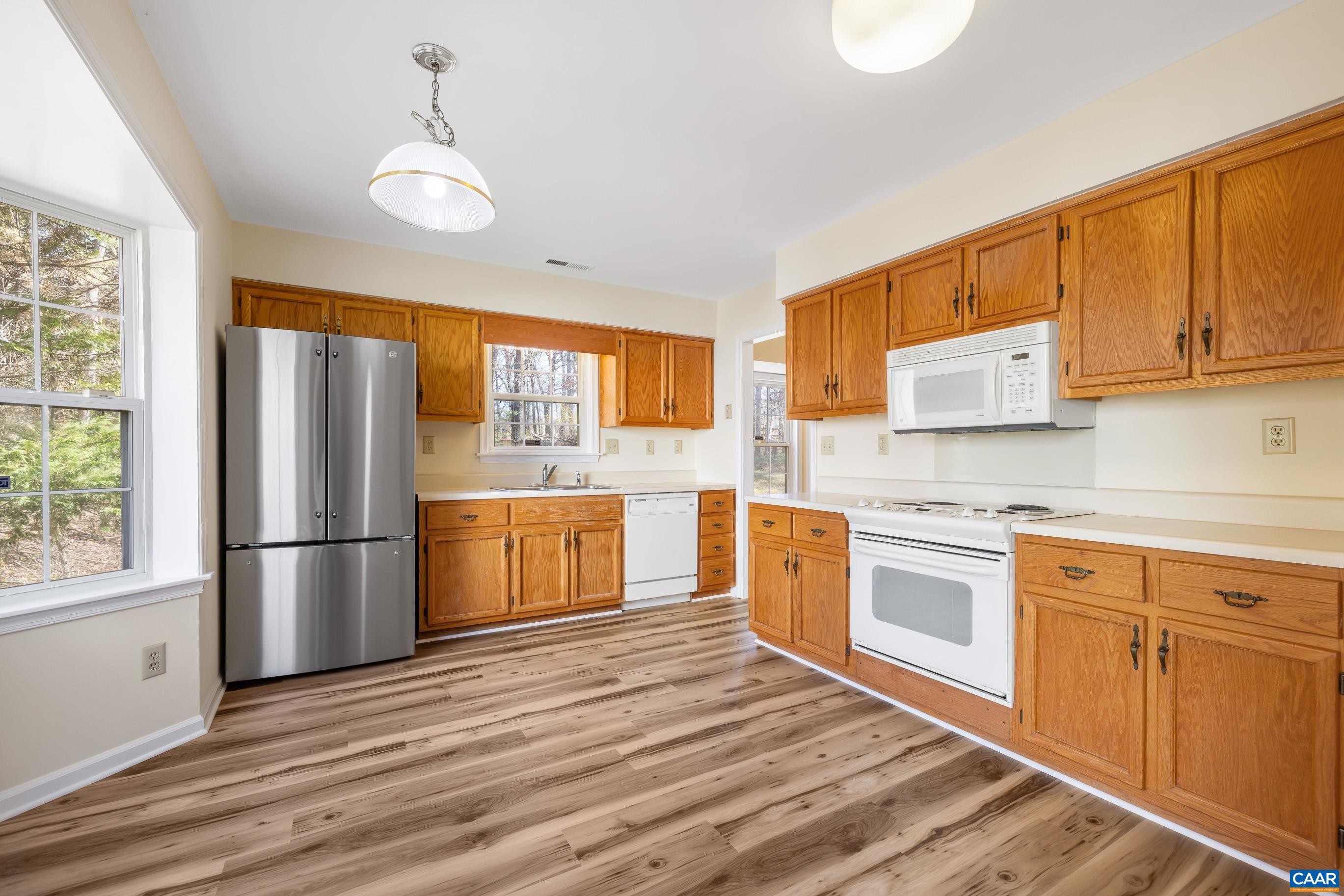 3041 Copper Knoll Road Charlottesville, VA 22911 - Photo 10 of 30 a kitchen with granite countertop wooden floors and stainless steel appliances