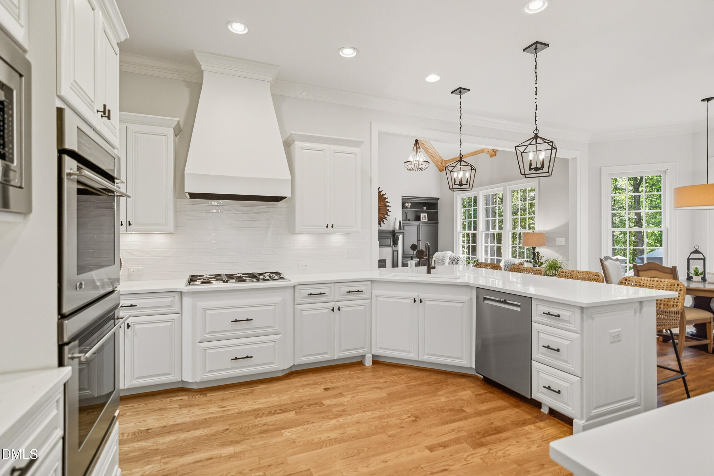 1409 Caistor Lane Raleigh, NC 27614 - Photo 12 of 46 a kitchen with stainless steel appliances granite countertop a stove a sink and white cabinets