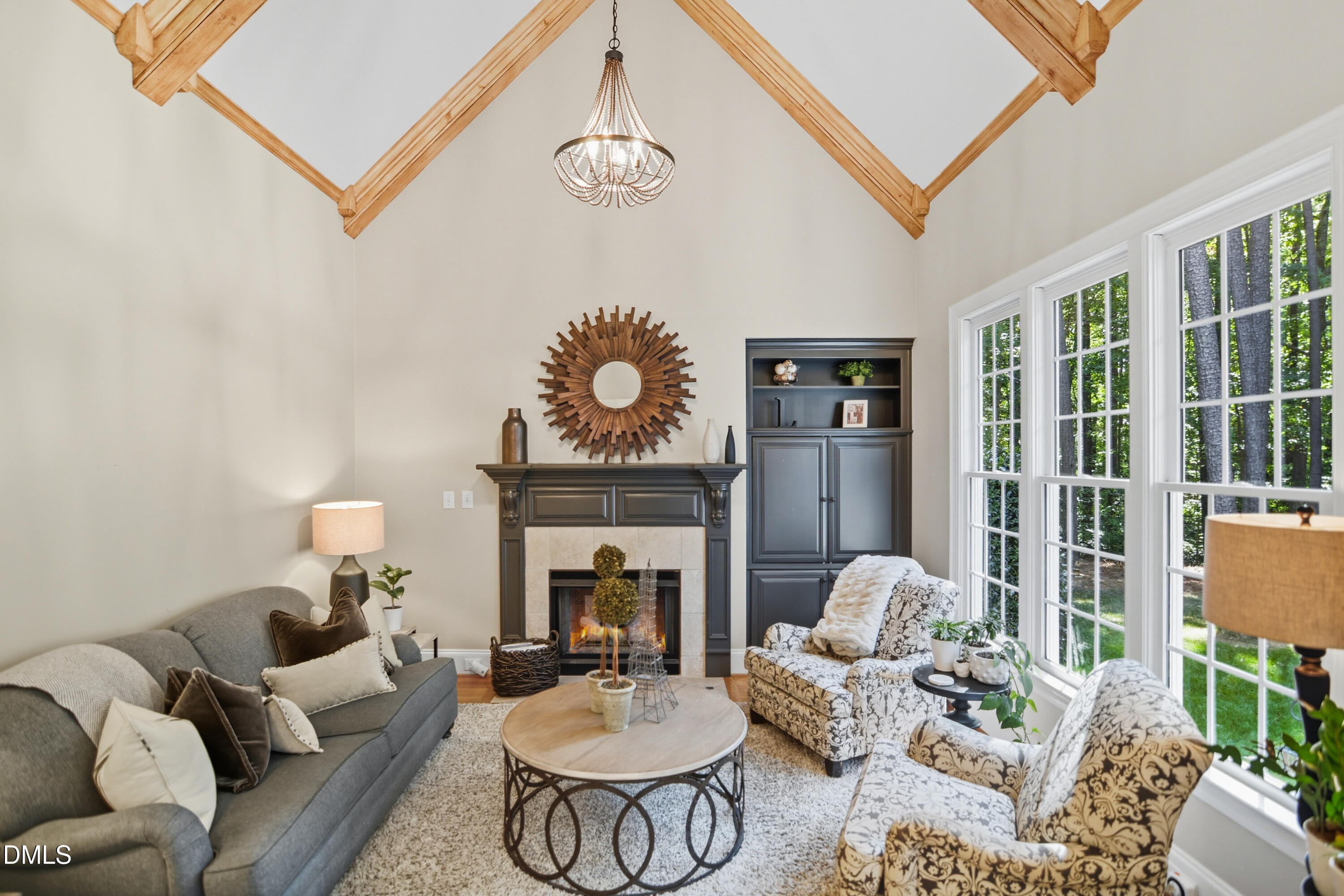 1409 Caistor Lane Raleigh, NC 27614 - Photo 15 of 46 a living room with furniture chandelier and a fireplace