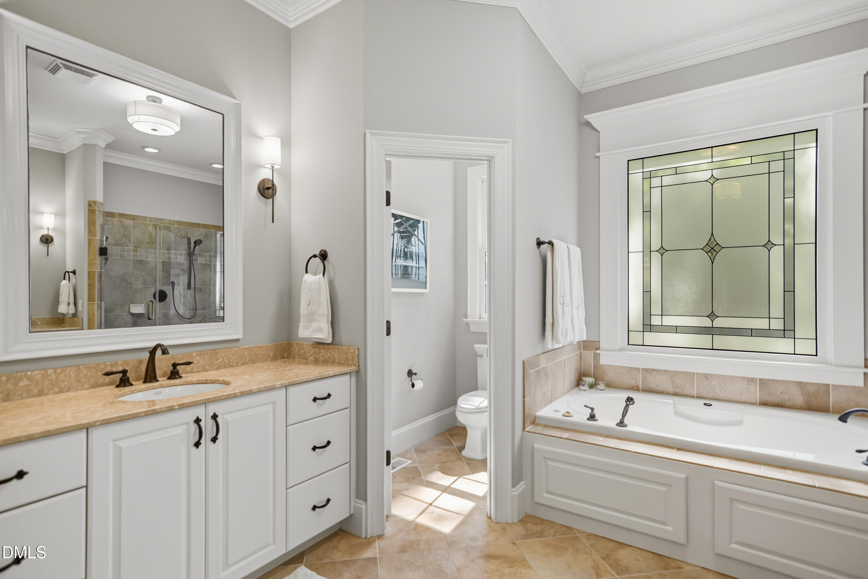 1409 Caistor Lane Raleigh, NC 27614 - Photo 19 of 46 a bathroom with a tub a sink and a large mirror
