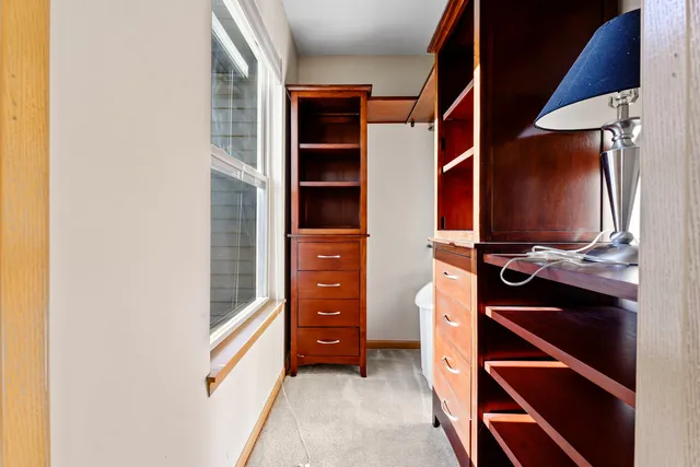 an empty room with closet and a bathroom