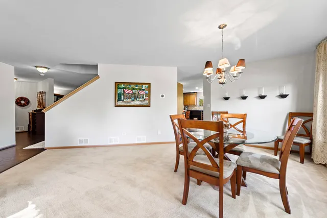a dining room with furniture and chandelier