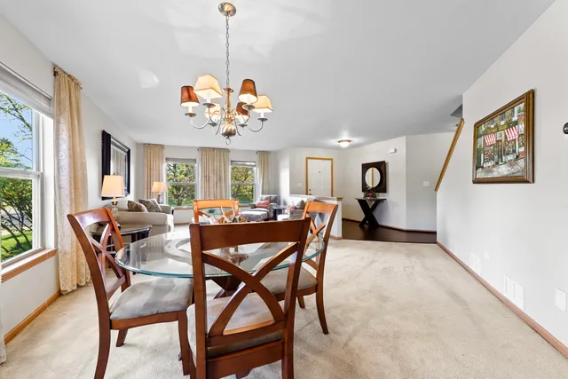 a view of a dining room and a livingroom with furniture window and wooden floor