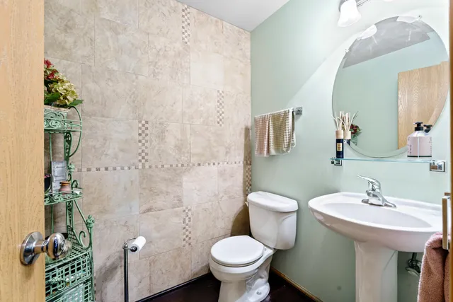 a bathroom with a sink toilet and a mirror