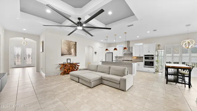a living room with furniture and kitchen view
