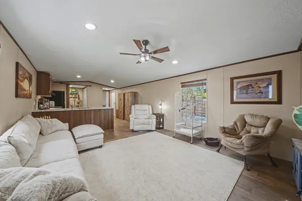 a living room with furniture ceiling fan and a rug