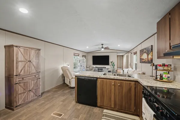 a kitchen with kitchen island a refrigerator stove and sink