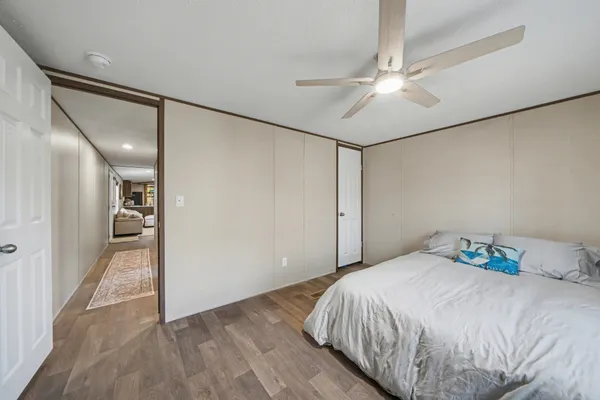 a bedroom with a bed and a chandelier