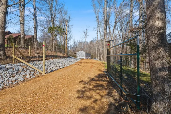 a view of a yard with wooden fence
