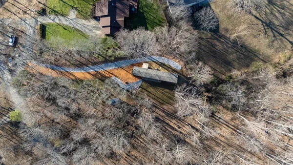 a aerial view of a house with a yard