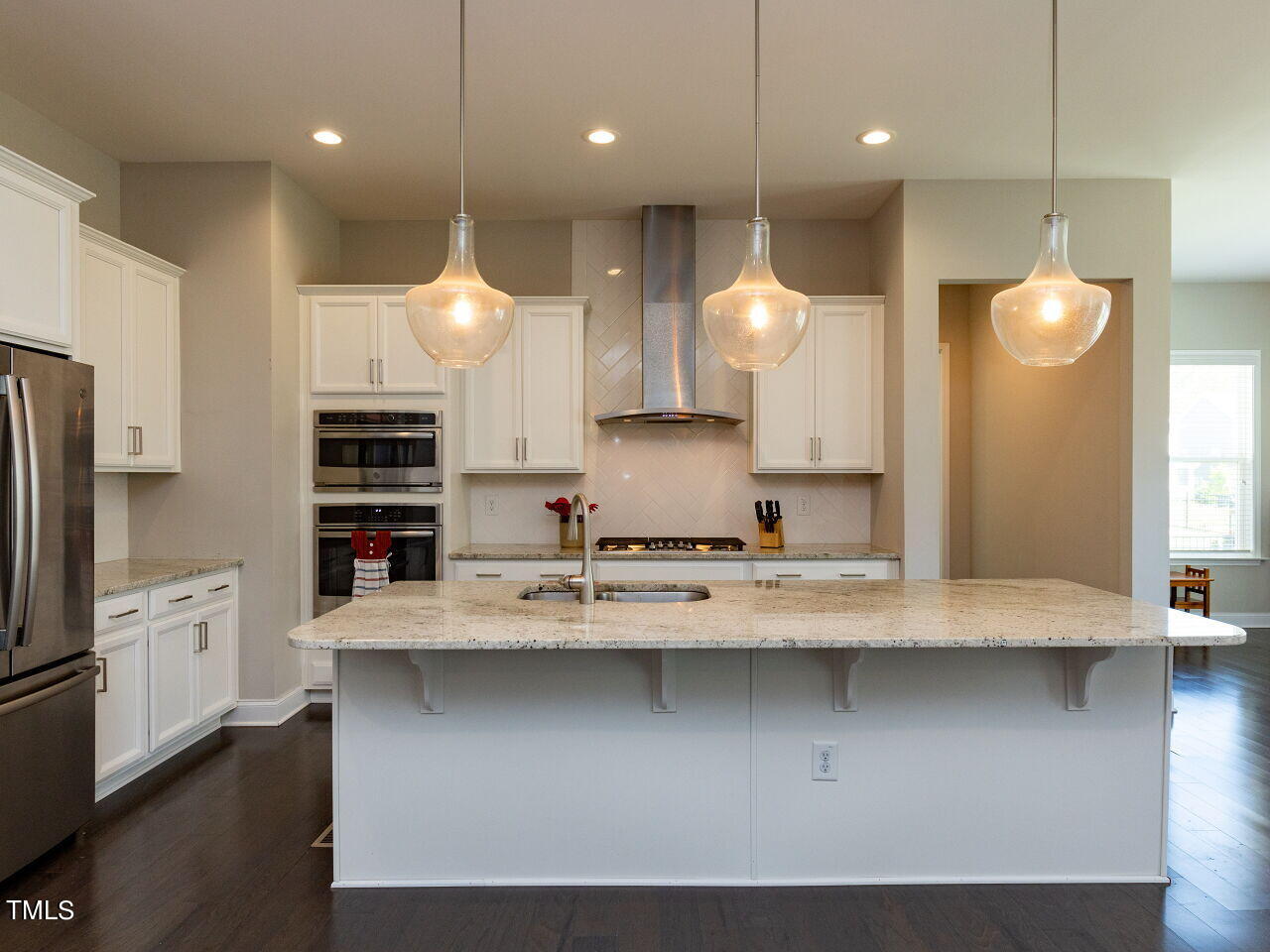 605 White Oak Pond Road Apex, NC 27523 - Photo 12 of 46 a open kitchen with a sink a refrigerator and a stove