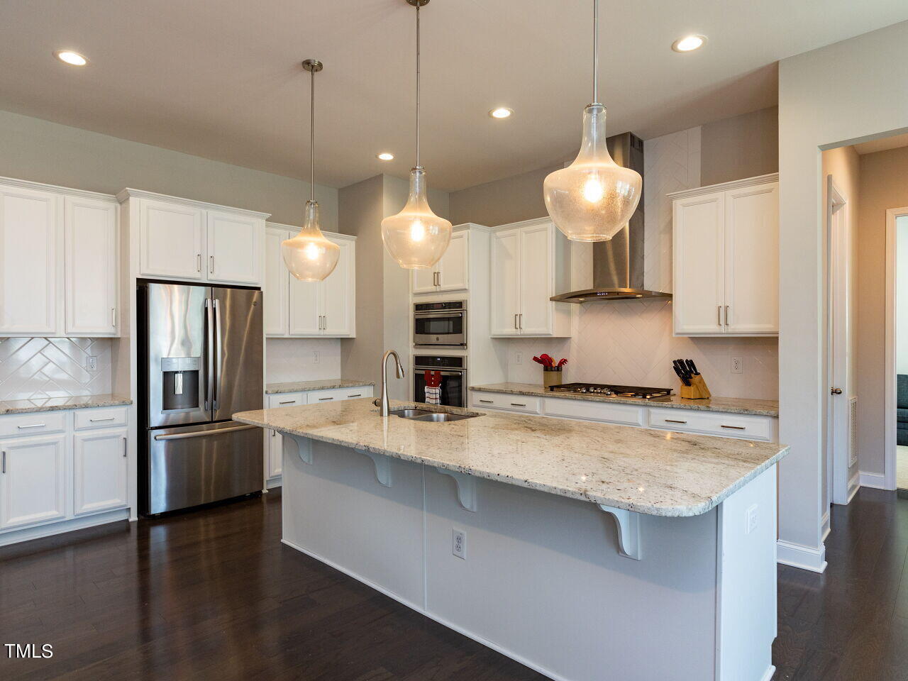 605 White Oak Pond Road Apex, NC 27523 - Photo 14 of 46 a kitchen with stainless steel appliances granite countertop a sink a stove and a refrigerator