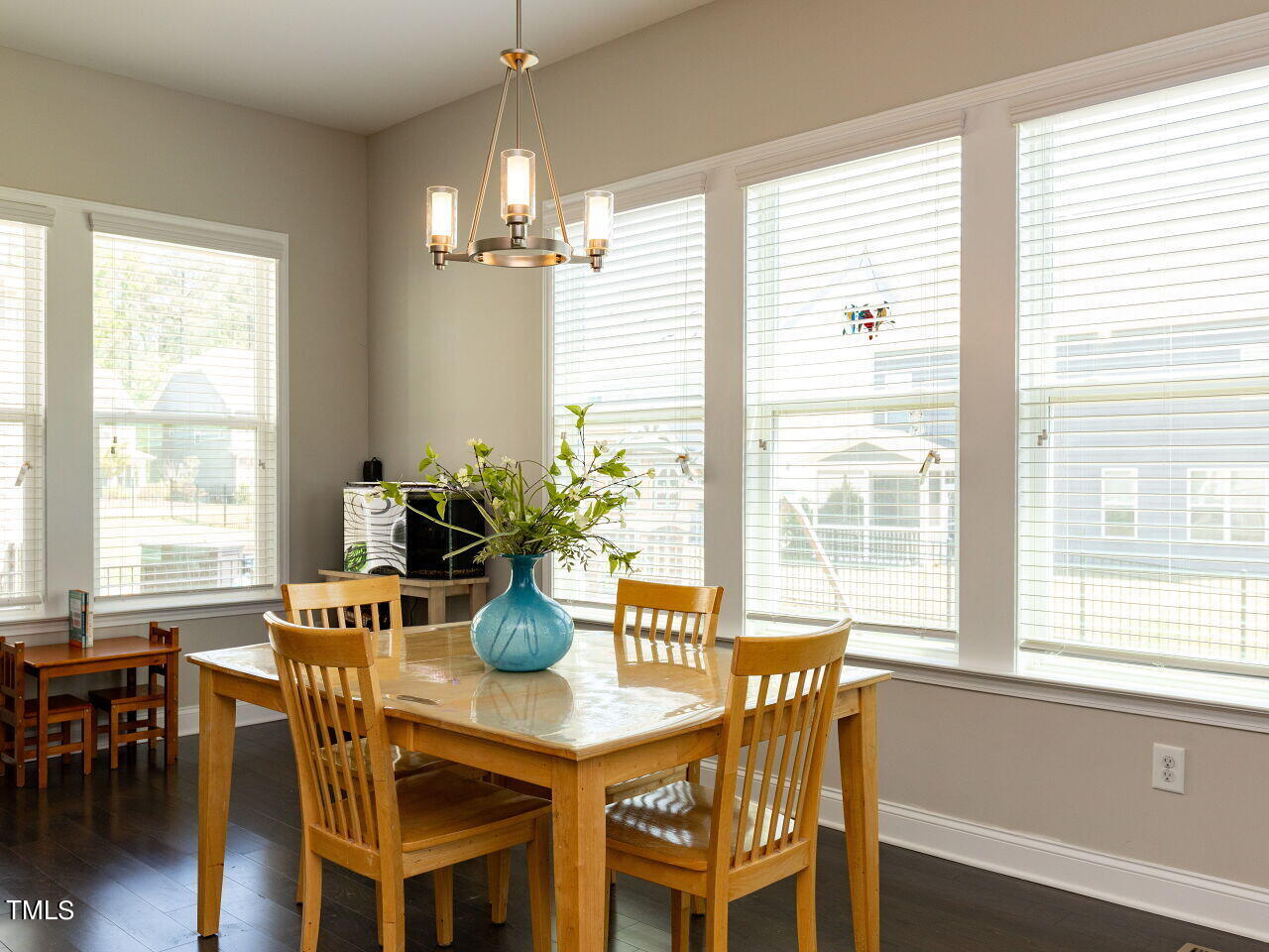 605 White Oak Pond Road Apex, NC 27523 - Photo 15 of 46 a dining room with furniture potted plants and wooden floor