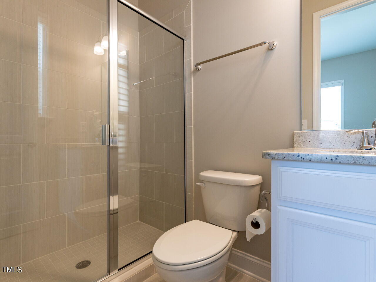 605 White Oak Pond Road Apex, NC 27523 - Photo 18 of 46 a bathroom with a granite countertop toilet a sink and shower