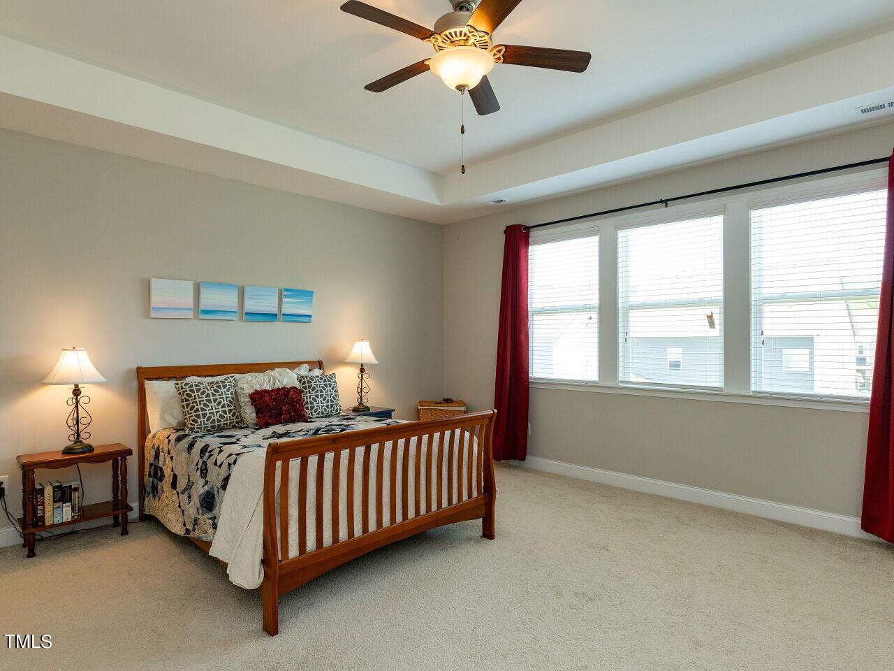 605 White Oak Pond Road Apex, NC 27523 - Photo 24 of 46 a bed room with a bed and a chandelier