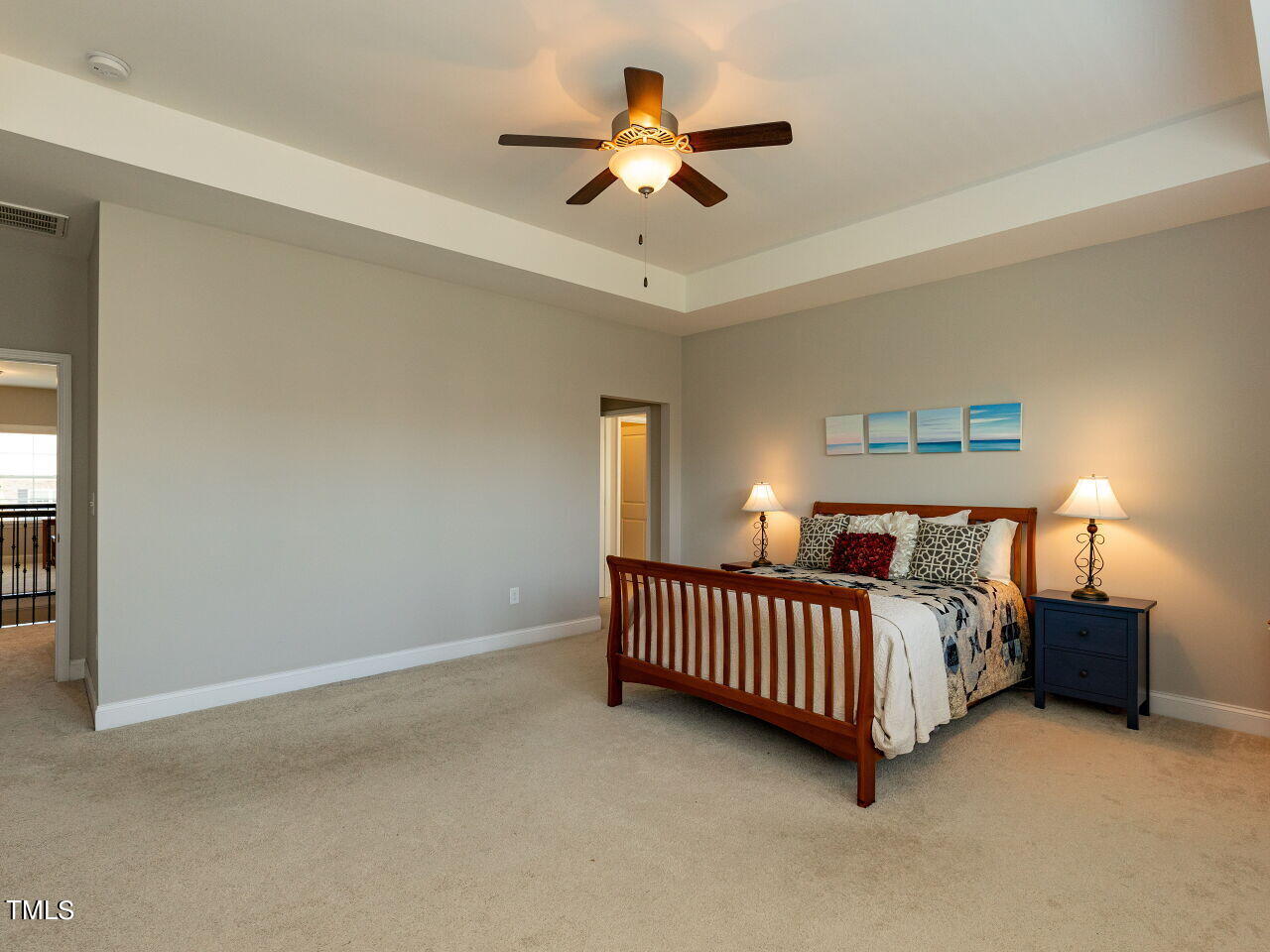 605 White Oak Pond Road Apex, NC 27523 - Photo 25 of 46 a bed room with a bed and a chandelier