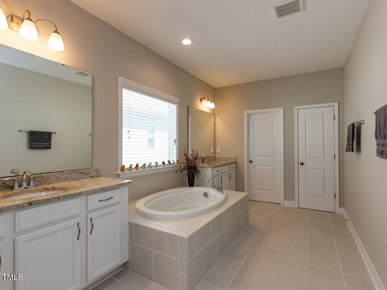 605 White Oak Pond Road Apex, NC 27523 - Photo 27 of 46 a bathroom with a sink and a mirror