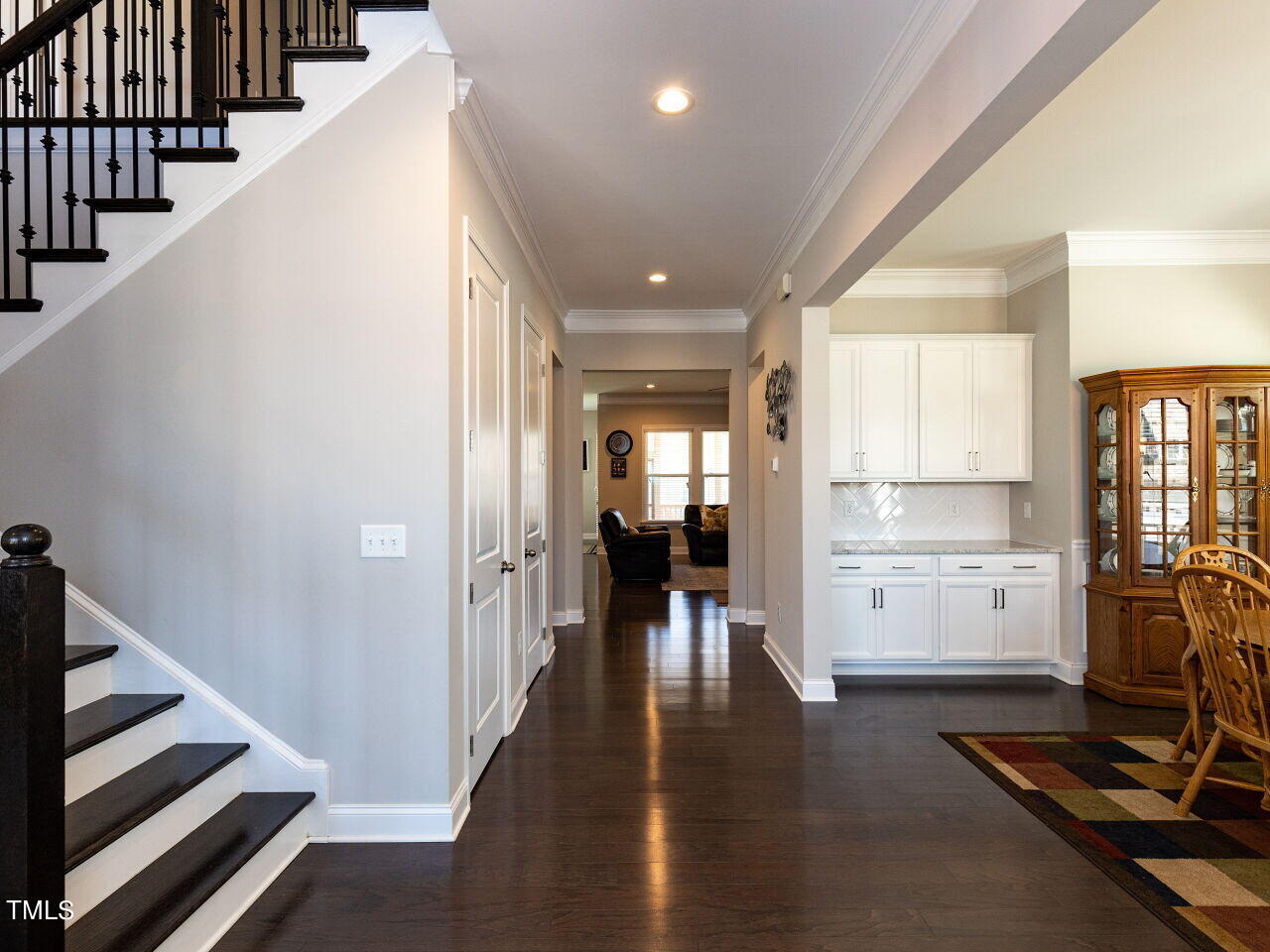 605 White Oak Pond Road Apex, NC 27523 - Photo 3 of 46 a view of a hallway with wooden floor and staircase
