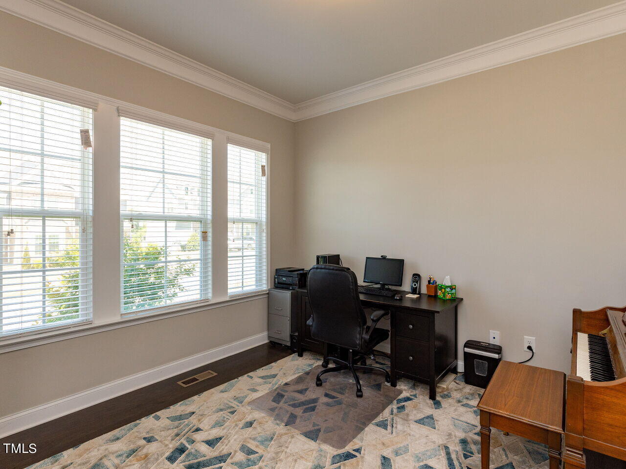 605 White Oak Pond Road Apex, NC 27523 - Photo 4 of 46 a view of a workspace with furniture and a window