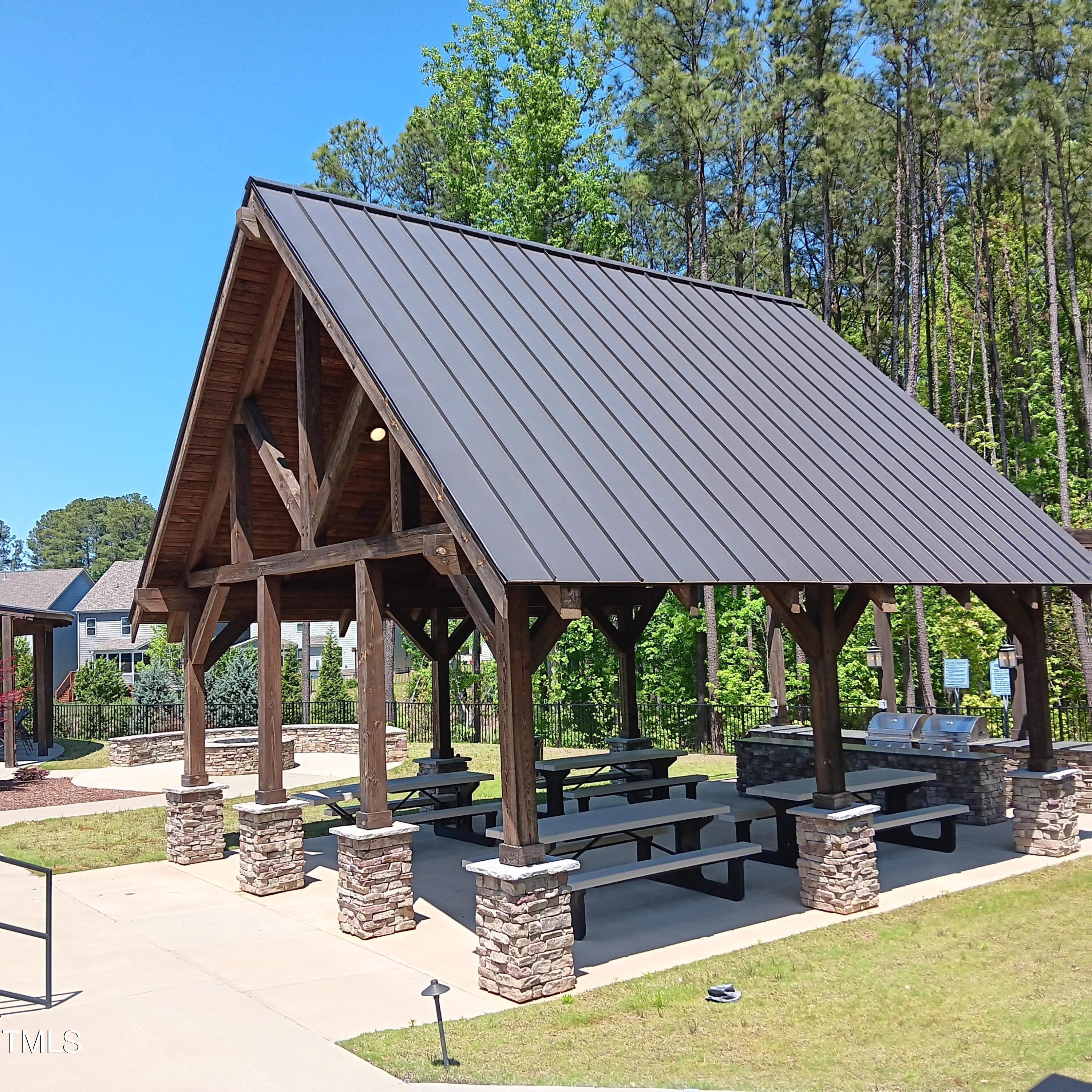 605 White Oak Pond Road Apex, NC 27523 - Photo 43 of 46 a patio with wooden table and chairs