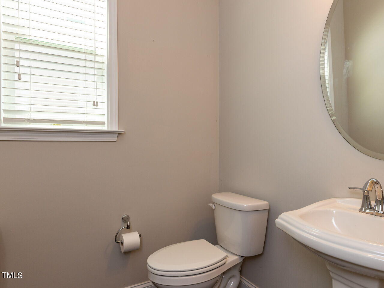 605 White Oak Pond Road Apex, NC 27523 - Photo 7 of 46 a white toilet sitting next to a bathroom sink