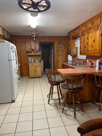 a kitchen with stainless steel appliances kitchen island granite countertop a refrigerator and a stove