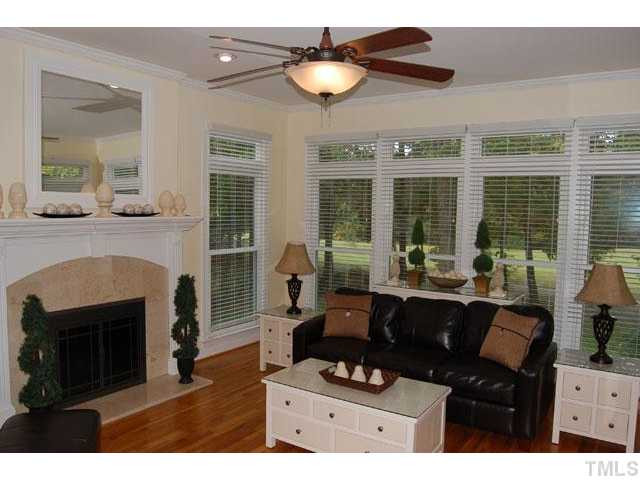 5100 Salem Ridge Road Holly Springs, NC 27540 - Photo 4 of 25 The spacious family room hosts a marble surround gas fireplace, hardwood floors, a ceiling fan with light, a French door leading to the back deck, and a wall of windows. Den/Family/Great Room