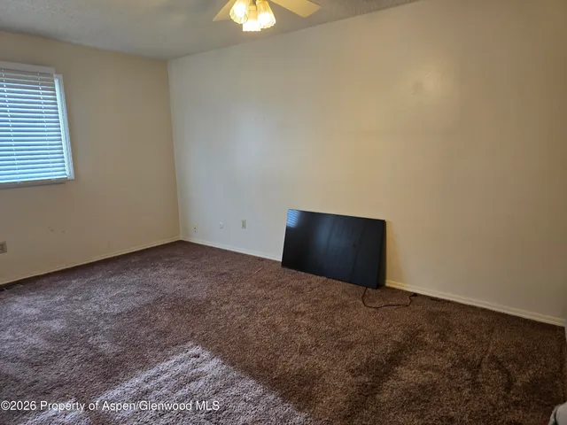 a view of a room with a fan and a window