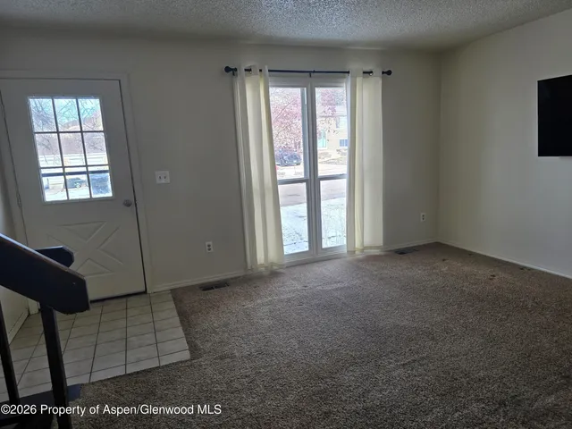 a view of an empty room with a window