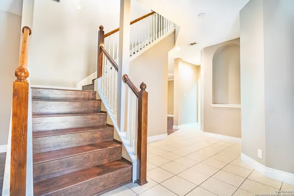 a view of staircase with white walls and railing