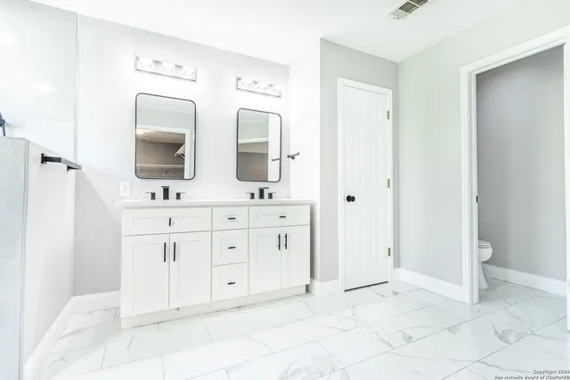 a bathroom with a glass shower door