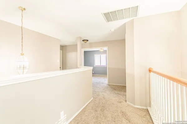 a view of balcony with wooden floor and seating space