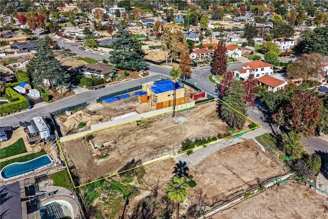 an aerial view of a house with a yard