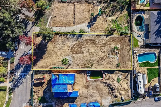 an aerial view of a house with a mountain