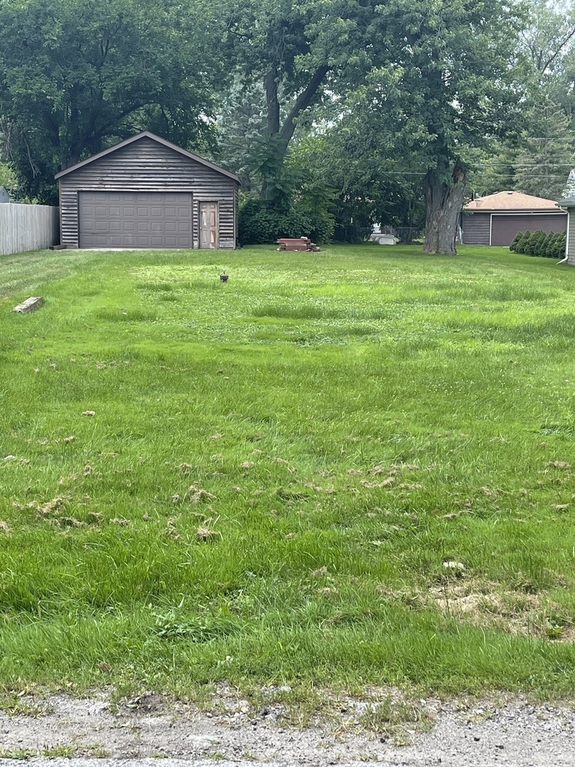 17934 Locust Street Lansing, IL 60438 - Photo 2 of 2 a backyard of a house with plants and large trees