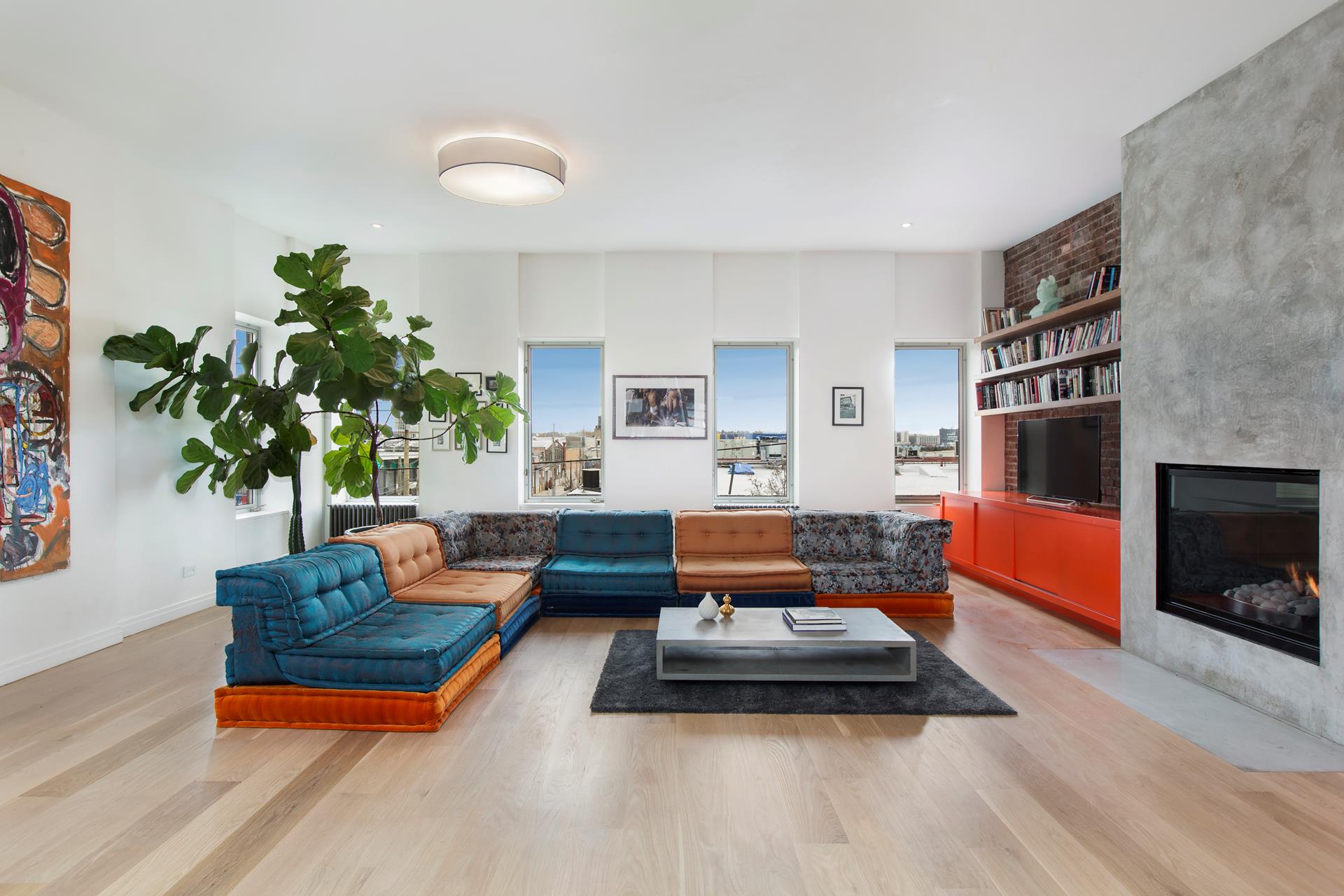 a living room with furniture and a fireplace
