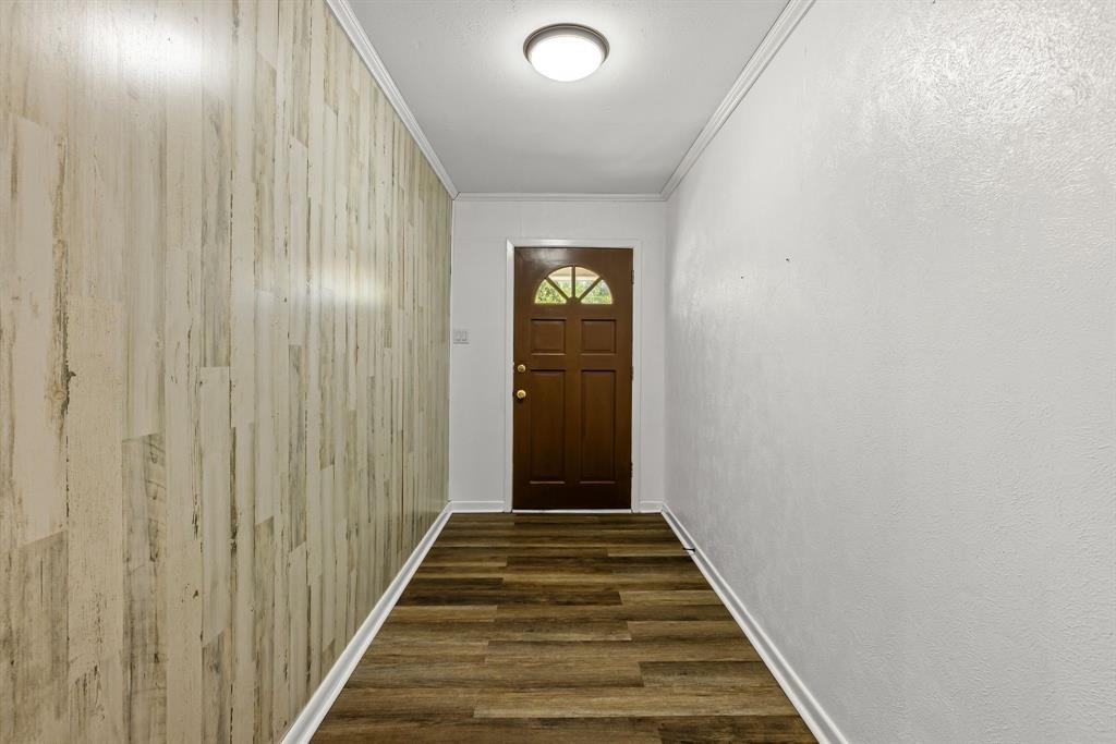 148 Royal Lane Commerce, TX 75428 - Photo 12 of 38 a view of a hallway with wooden floor and staircase
